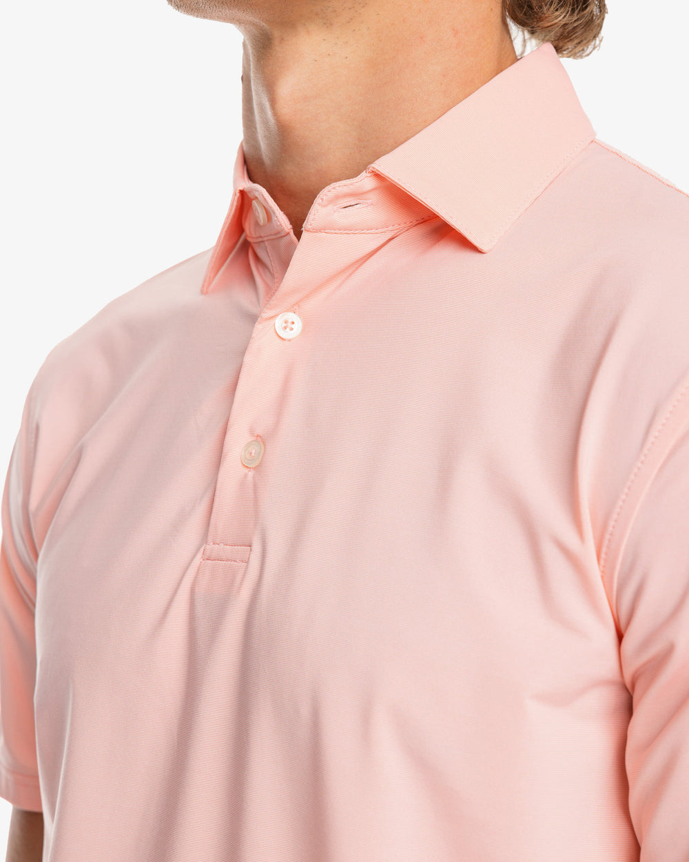 The model detail view of the Men's Sawgrass Stripe brrr°®-eeze Performance Polo Shirt by Southern Tide - Sunbaked Sand