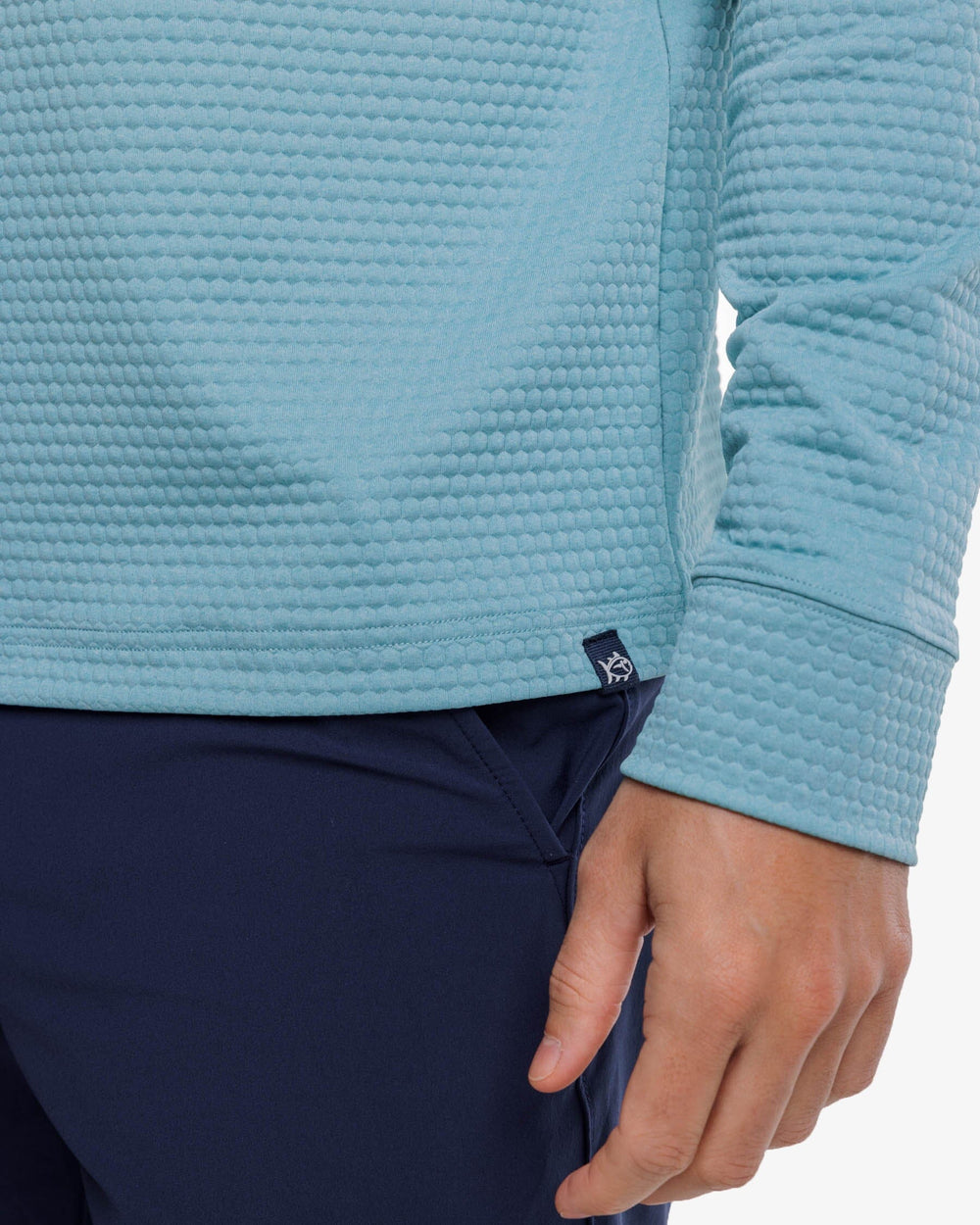 The label view of the Southern Tide Scuttle Heather Performance Quarter Zip Hoodie by Southern Tide - Heather Ocean Teal