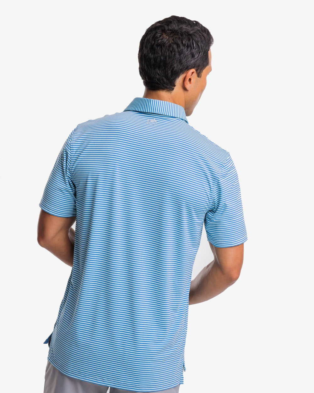 The back view of the Southern Tide Shores Stripe brrr eeze Performance Polo Shirt by Southern Tide - Baltic Teal