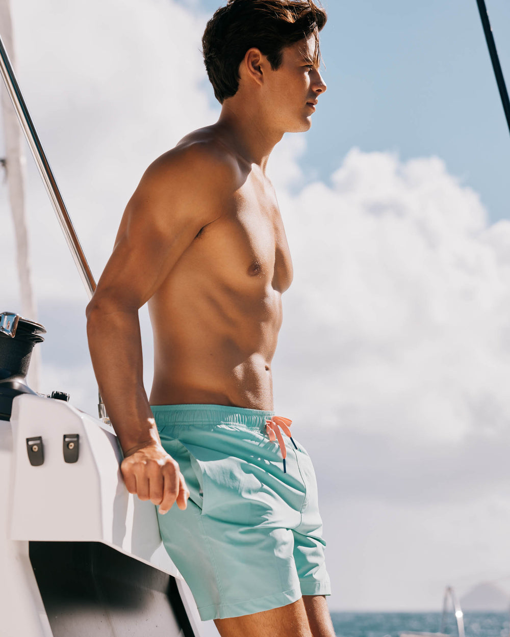 The model lifestyle view of the Men's Solid Swim Trunk by Southern Tide - Isle of Pines