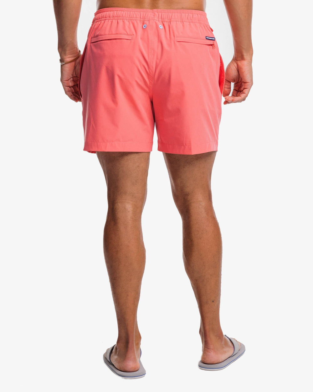 The back view of the Southern Tide Solid Swim Trunk 3 by Southern Tide - Sunkist Coral