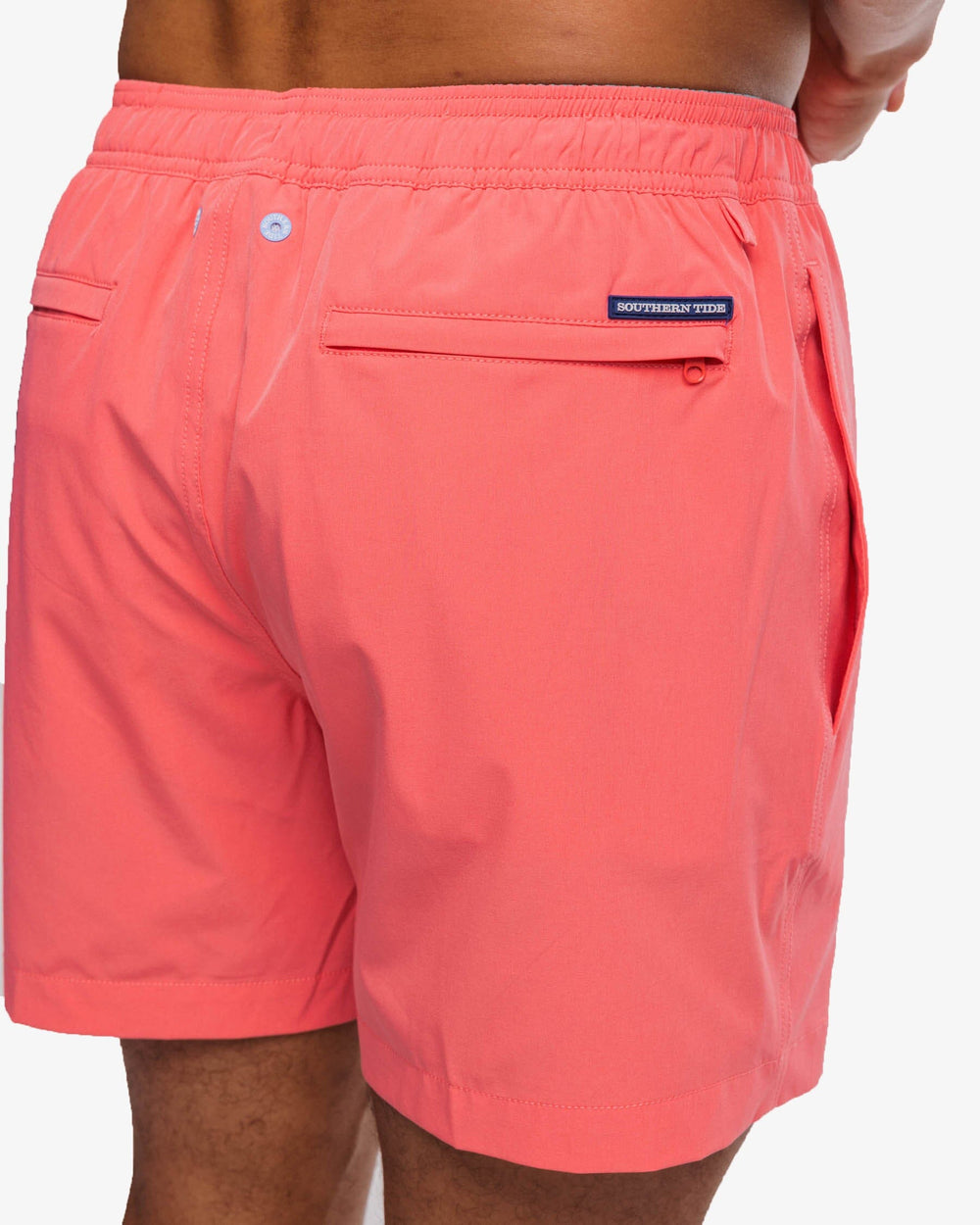 The detail view of the Southern Tide Solid Swim Trunk 3 by Southern Tide - Sunkist Coral