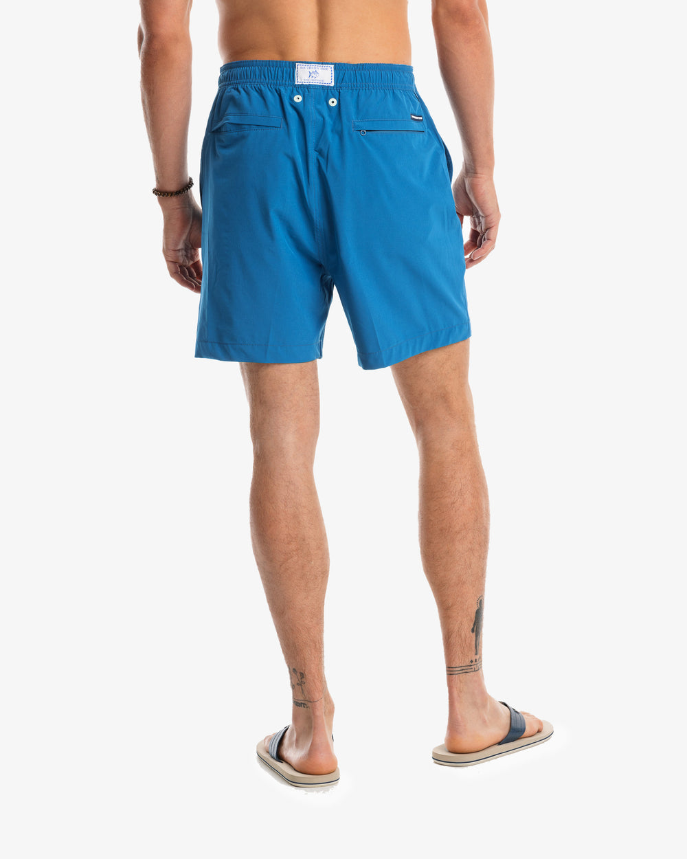The model back view of the Men's Solid Swim Trunk by Southern Tide - Blue Sapphire
