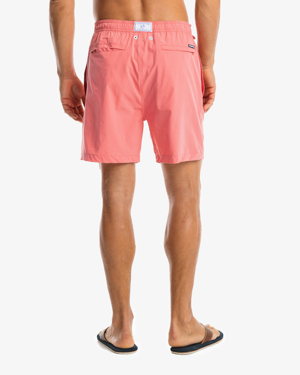 The model back view of the Men's Solid Swim Trunk by Southern Tide - Rouge Red