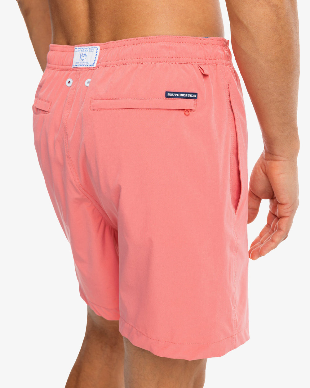 The model detail view of the Men's Solid Swim Trunk by Southern Tide - Rouge Red