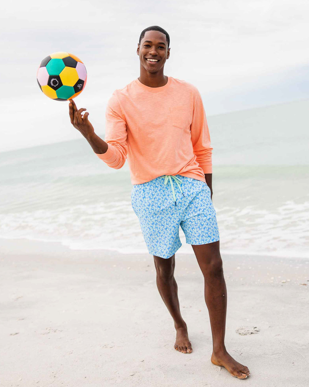 The model lifestyle view of the Men's Sun Farer Long Sleeve T-Shirt by Southern Tide - Sunbaked Sand