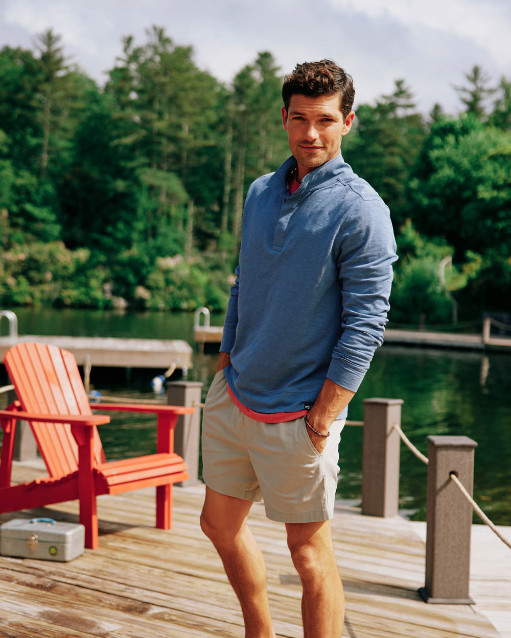 The front lifestyle view of the Sun Farer Ocean View Quarter Button Pullover by Southern Tide - Blue Haze
