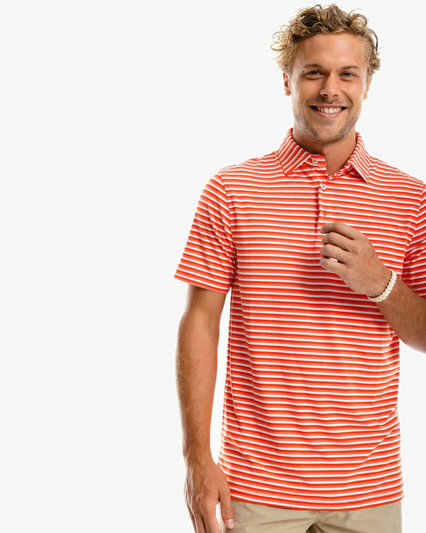 The front of the Men's Team Colors Ryder Heathered Striped Performance Polo Shirt by Southern Tide - Endzone Orange
