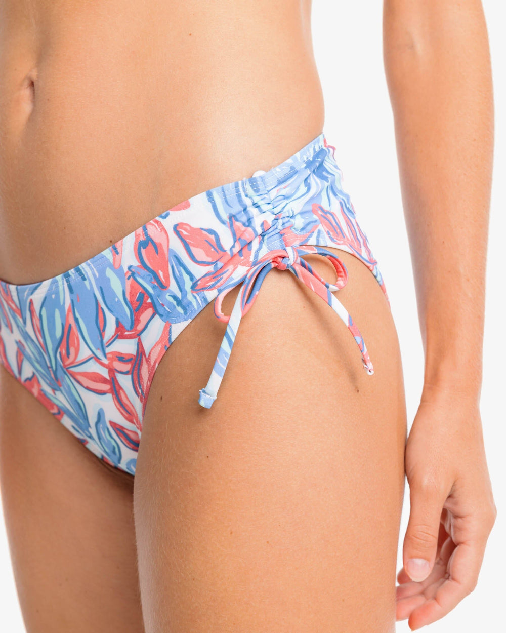 The detail view of the Southern Tide TGIFloral Bikini Bottom by Southern Tide - Sunkist Coral